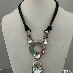 Bold Silver tone necklace on double black cord. Excellent condition